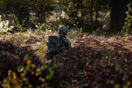 cadet masked in woodland kneeling down