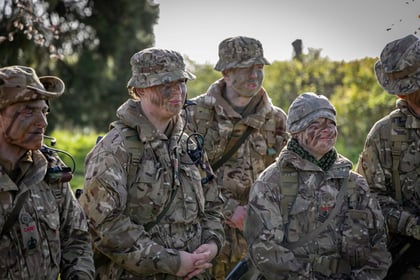 group of senior cadets in camouflage with camps on