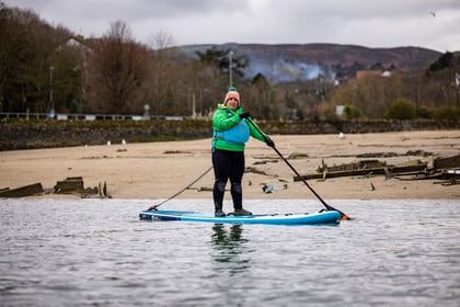 Adult volunteer on stand up paddle board
