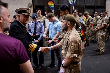 Adult volunteer shakes hands with senior officer of the MOD