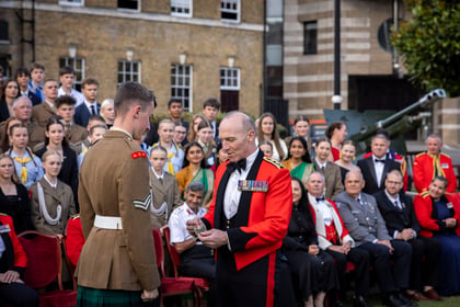 Brigadier presents rank slide to cadet