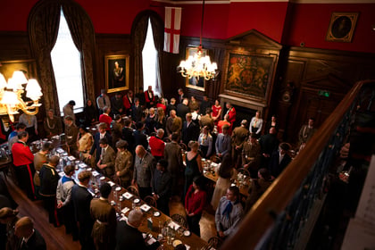 Aerial shot of cadets and adult volunteers taking their seats at International Exchange Dinner