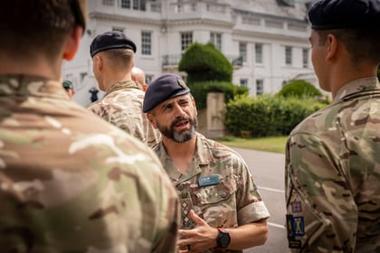 Senior Officer speaks to cadets at Champion Cadet Competition parade with the Frimley building in the background