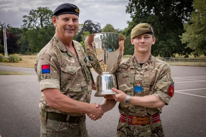 Senior Officer presents silver trophy to the CCF winner of the Champion Cadet Competition