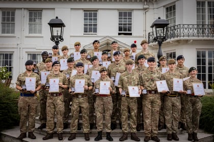 Cadets who participated in the Champion Cadet Competition stand on the steps of Frimley Park with their certificates and coins