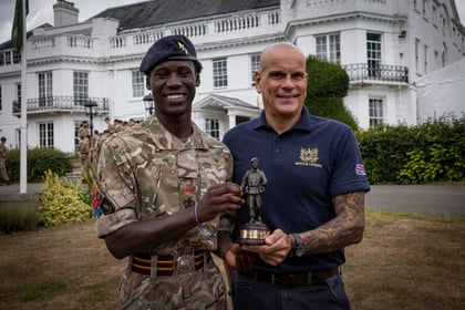 Cadet and sponsor stand together with his trophy