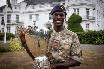 ACF winner of the Champion Cadet Competition stands with his trophy
