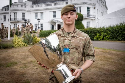 CCF winner of the Champion Cadet Competition stands with his trophy