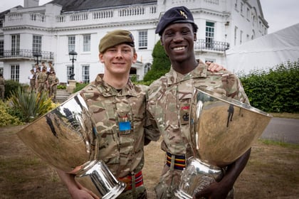 Two winners of the Champion Cadet Competition stand together with their trophies