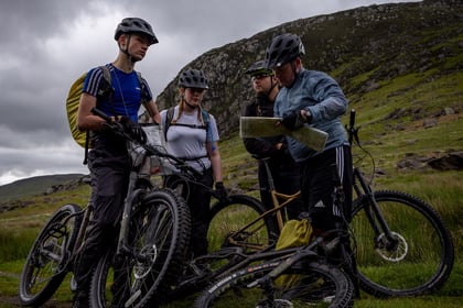 Cadets and volunteers pause on the mountain side during biking