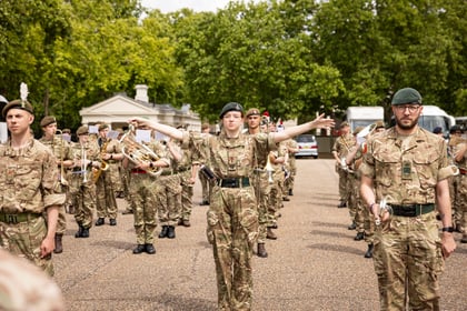 Rehearsals for the Military Music Spectacular cadet stands with arms out while marching