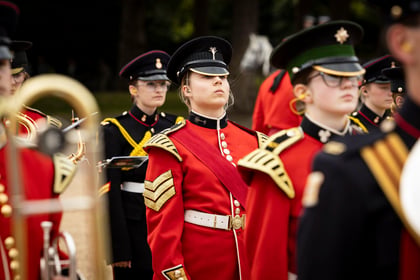 Cadets stands in ceremonial uniform poised to start playing their instruments