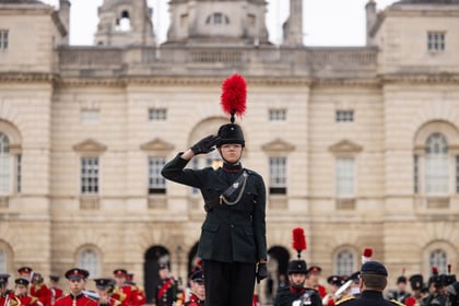 The master in ceremonial uniform participates in a military band performance at the Horse Guards in London.