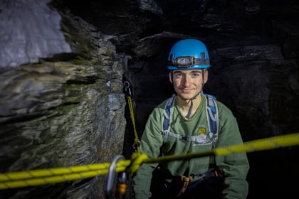 Cadet smiles at the camera while doing caving in a mine