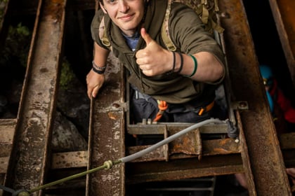 Cadet from the International Exchange climbing through boarding in a mine
