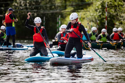Cadet kneel on the paddle boards