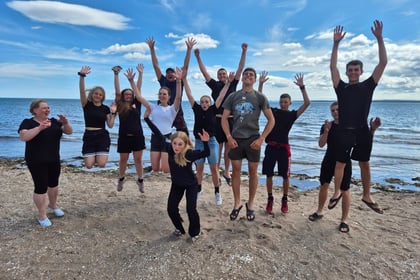 Cadets enjoy time on the beach jumping up in the air