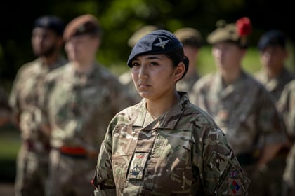 Female cadet stands at attention