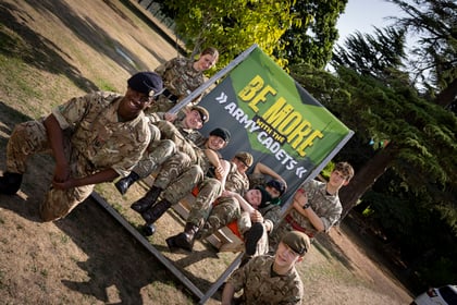 Cadets pose on the Be More with the Army Cadet deck chair