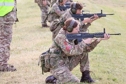 Female cadet firing weapon