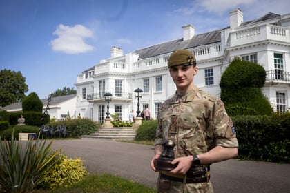 Top student from the Master Cadet Course stands proudly with this trophy