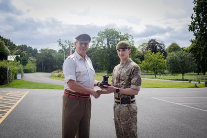 CO of Frimley Park stands with top student and presents him with his award