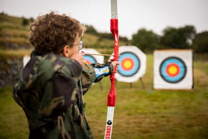 Cadet doing archery with bow positioned at the target