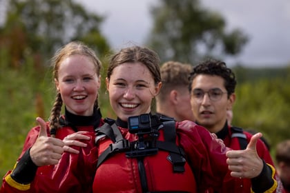 Female cadet smiles with thumbs up after doing water sports