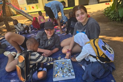 Cadets from Cambridgeshire ACF playing puzzles with young kids