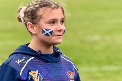 Scottish cadet with blonde hair wearing rugby uniform with Scottish flag on cheek