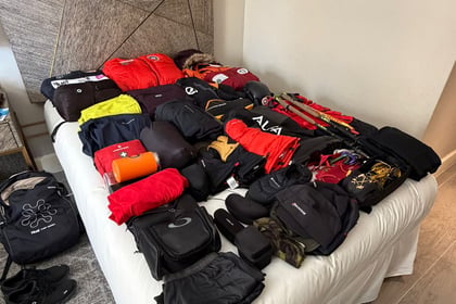 Expedition clothes laid out on the bed