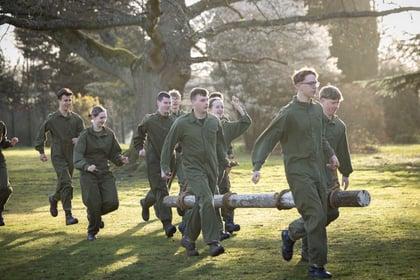 Cadets run with log on log run for the Master Cadet course