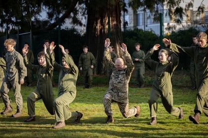 The Brigadier does a warm up exercise with cadets