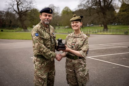 CO from Frimley Park CTC shakes hands and hands over trophy to top student