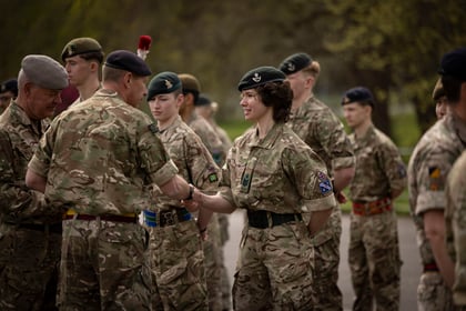 Female cadet shakes hands with instructor