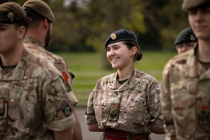 Female cadet smiles while speaking to an instructor on the Master Cadet Course Final Parade