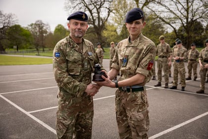 CO of Frimley Park shakes hands with top student of Master Cadet Course and presents his trophy