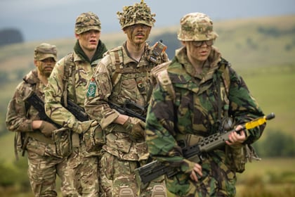 Four cadets dressed in uniform wielding weapons during fieldcraft exercise at Cadet Cambrian Patrol 2026