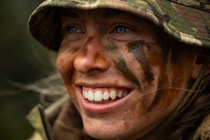 Female cadet smiles at the camera