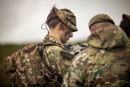 A male cadet looking at his weapon during fieldcraft exercise at Cadet Cambrian Patrol 2026