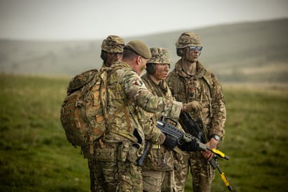 Adult instructor gives instructions to a group of cadets