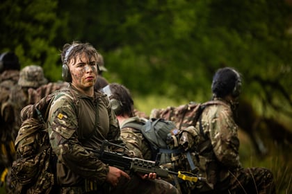 A male cadet surrounded by his team mates during fieldcraft exercise at Cadet Cambrian Patrol 2026