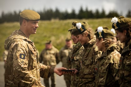 Female cadets receive medals from an adult instructor at Cadet Cambrian Patrol 2026