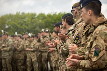 A row of cadets clapping during a presentation