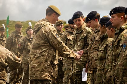 male cadet receives a medal from an adult instructor at Cadet Cambrian Patrol 2026