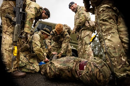 Cadets attend to casualty at first aid scenario