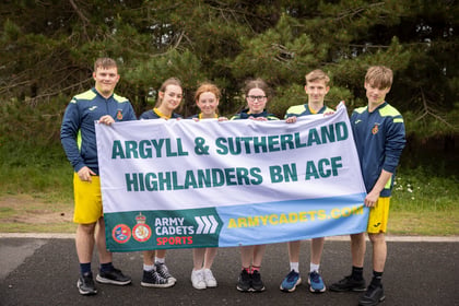 Cadets at Rivalry Sports Cup hold up their team banner