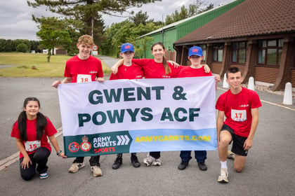 Cadet team from Wales hold up their team banner
