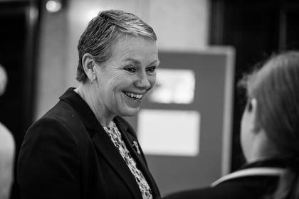 Sally Orange smiling while speaking with a guest