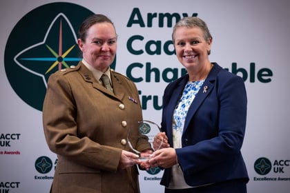 Sally Orange presents an award to an adult volunteer